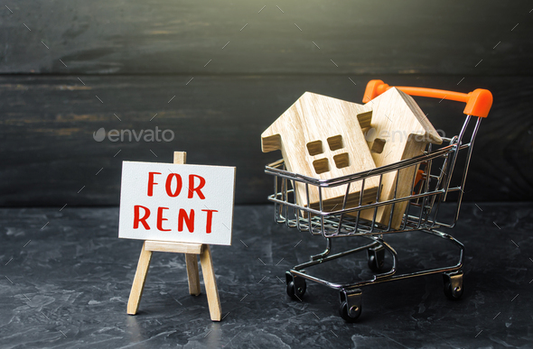 Homes in a shopping cart and for rent easel. Real estate realtor services.  - Stock Photo - Images