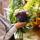 White beautiful young florist girl making bouquet with flowers in shop - PhotoDune Item for Sale