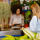African american florist girl working with customer in flower shop - PhotoDune Item for Sale