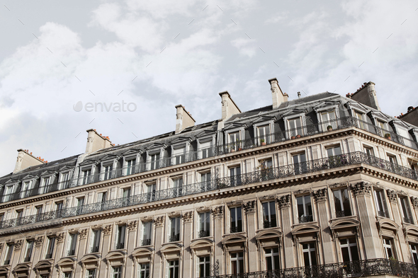 Parisian apartments and cloudy sky on background - Stock Photo - Images