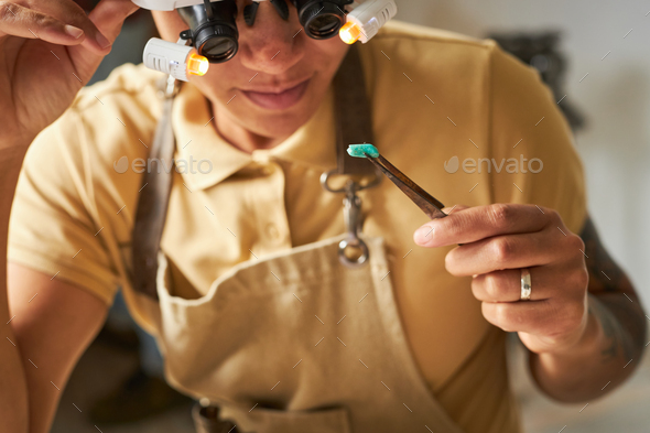 Female jeweler inspecting gem - Stock Photo - Images