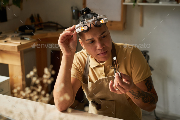 Tattooed female artist looking at camera and smiling - Stock Photo - Images