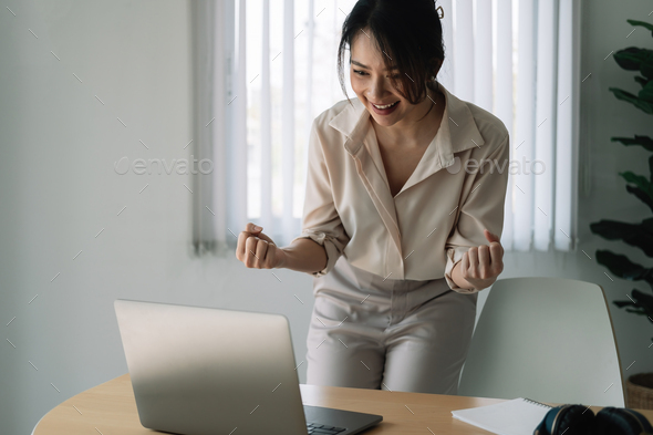 Excited Asian Businesswoman Celebrating Success At Workplace. - Stock Photo - Images