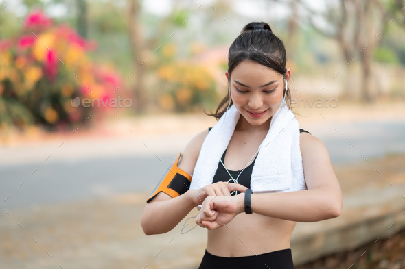 Young woman workout at outdoor using smart watch healthy lifestyle. - Stock Photo - Images