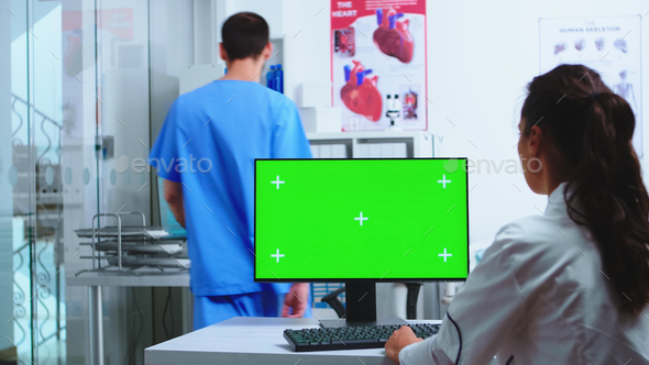 Physician using computer with chroma key