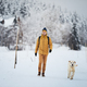 Man with dog during winter day in snowy landscape - PhotoDune Item for Sale