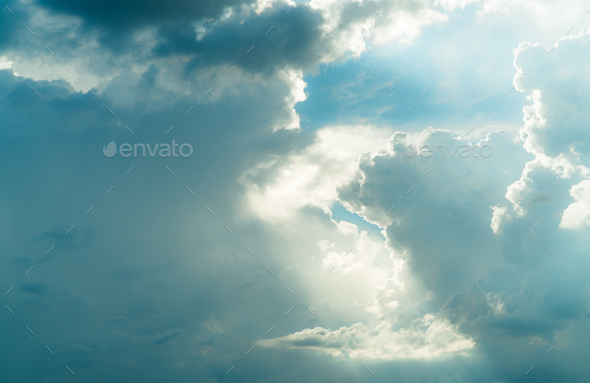 God light. White and blue cloudy sky with sun beam. Sun rays through white clouds. God light