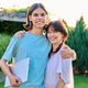 Outdoor portrait of happy embracing couple of teenage students - PhotoDune Item for Sale