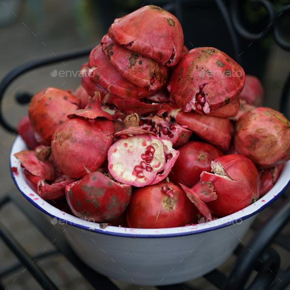 Waste from pomegranate fruit without grains in enamel bowl after