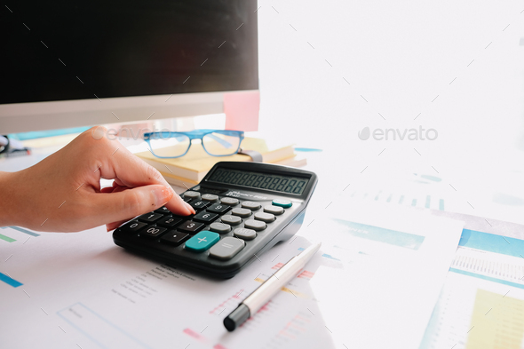 Close up of female accountant or banker making calculations. Savings, finance and economy concept - Stock Photo - Images