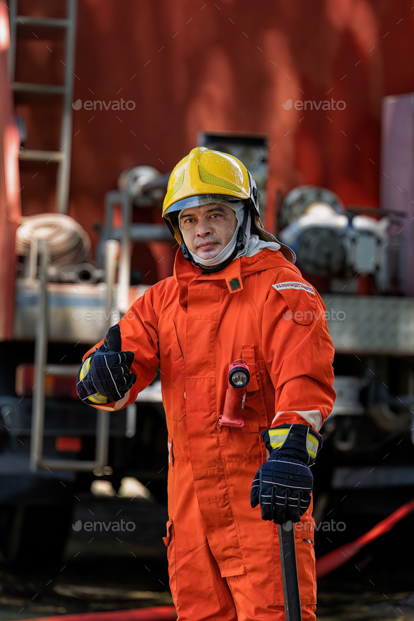 Fireman wearing fire protection suite and oxygen tank exercise hold axe ...