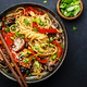 Vegan stir fry egg noodles with vegetables, paprika, mushrooms, chives and sesame seeds in bowl. - PhotoDune Item for Sale