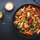 Stir fry with turkey fillet, paprika, mushrooms, green chives and sesame seeds in frying pan - PhotoDune Item for Sale