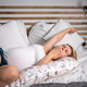 Beautiful pregnant woman relaxing in comfortable bed with pregnancy pillow - PhotoDune Item for Sale