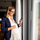 Pregnant woman remote work using smartphone from her home - PhotoDune Item for Sale