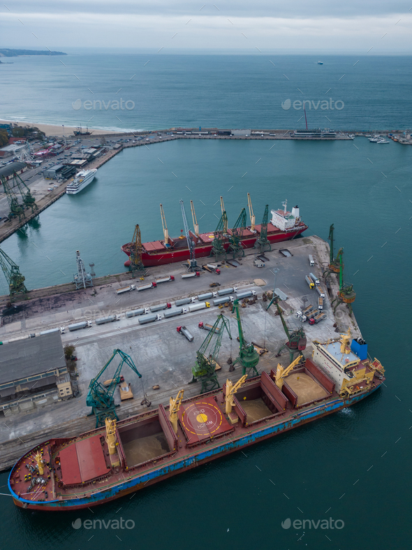 Aerial view of big cargo ship bulk carrier is loaded with grain of wheat in port - Stock Photo - Images