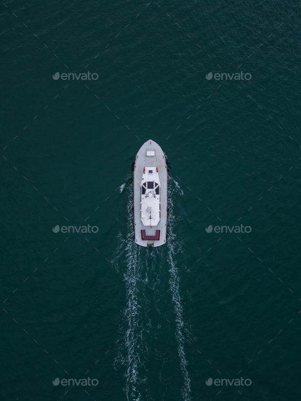 Aerial drone view of industrial tug assisting boat in deep sea - Stock Photo - Images