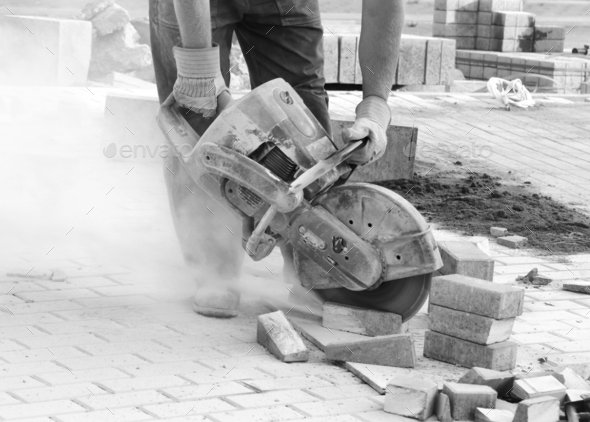 Construction worker with concrete saw working