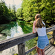 Back of girl stand in wooden bridge of emerald green water river Sava Bohinjka - PhotoDune Item for Sale