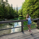 Back of girl stand in wooden bridge of emerald green water river Sava Bohinjka  - PhotoDune Item for Sale