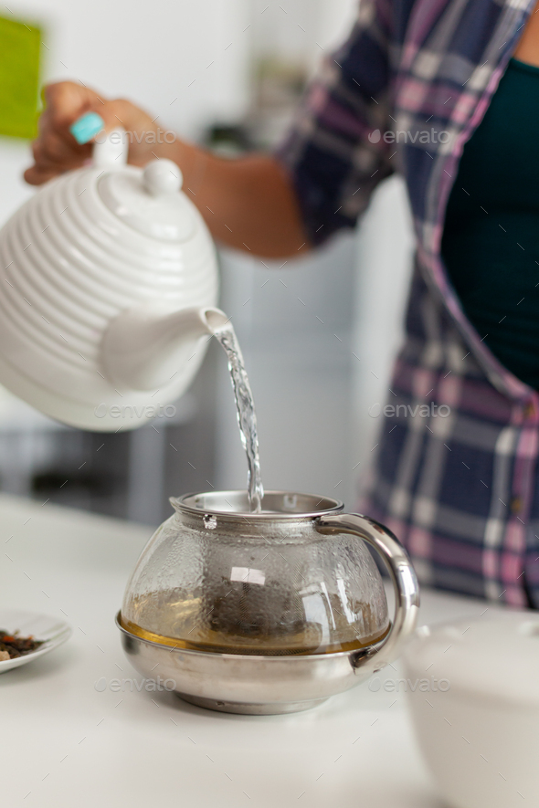 Lady making hot tea Stock Photo by DC_Studio PhotoDune