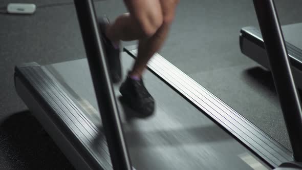 Runner Run on a Treadmill Aerobic Exercise and Endurance Training in the Gym View of the Legs alt