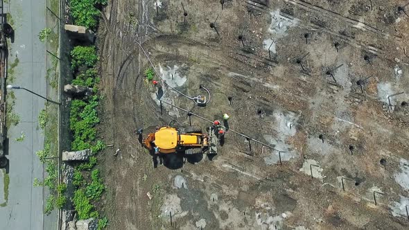 Team of Technicians Adjusting Big Shiny Solar Panel to Metal Platform alt