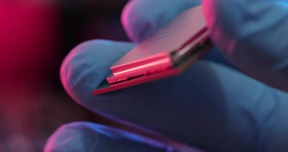 manipulating and installing processor on the motherboard in details with blur and selective focus alt