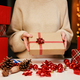Woman holding gift box in hands. Surprise for winter holidays - PhotoDune Item for Sale