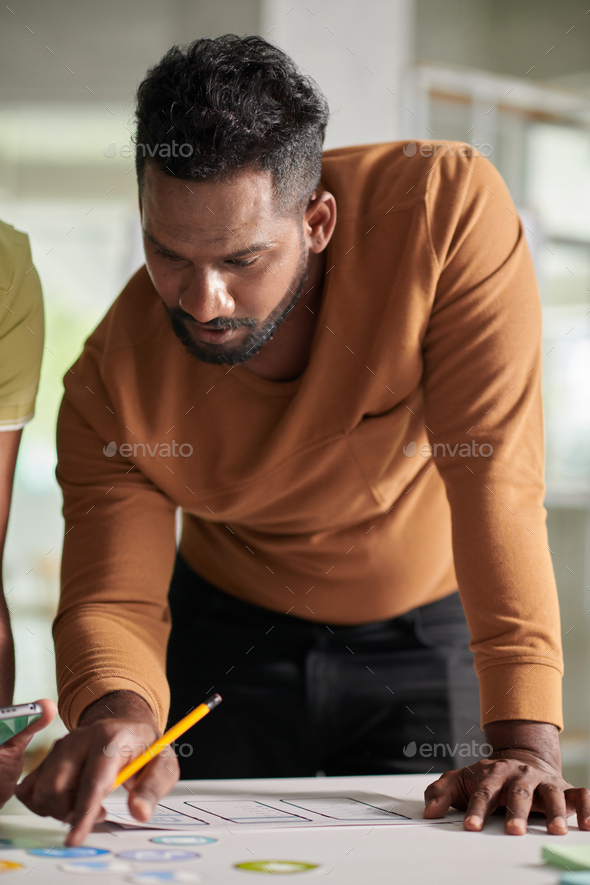 UX Designer Discussing Interface with Colleagues - Stock Photo - Images