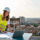Portrait of engineer businesswoman at construction site. Female architect with blueprint. - PhotoDune Item for Sale