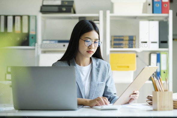 Young asian businesswoman working at office using laptop. - Stock Photo - Images