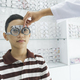 Young boy examining eyesight in optical clinic. - PhotoDune Item for Sale