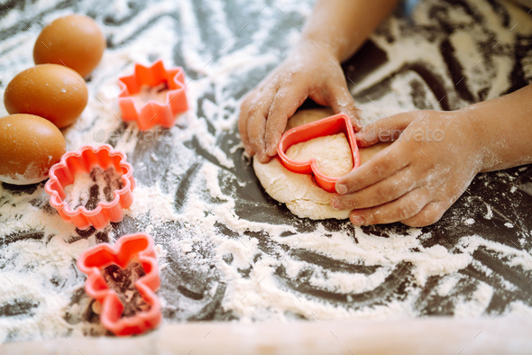 Kids hands cutting out shapes and making cookies. Children's art ...