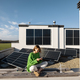 Woman on the roof of her house with a solar plant - PhotoDune Item for Sale