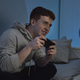 Caucasian teenage boy playing on game controller at night - PhotoDune Item for Sale