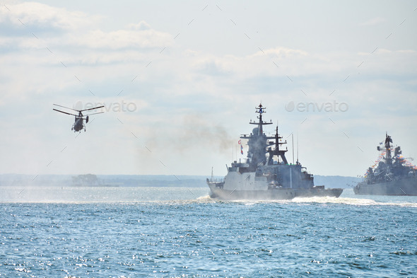 Battleships war ships corvette during naval exercises and helicopter maneuvering over sea, warships - Stock Photo - Images