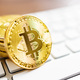 Cryptocurrency. Bitcoin virtual money. Gold coins laying on computer keyboard. - PhotoDune Item for Sale