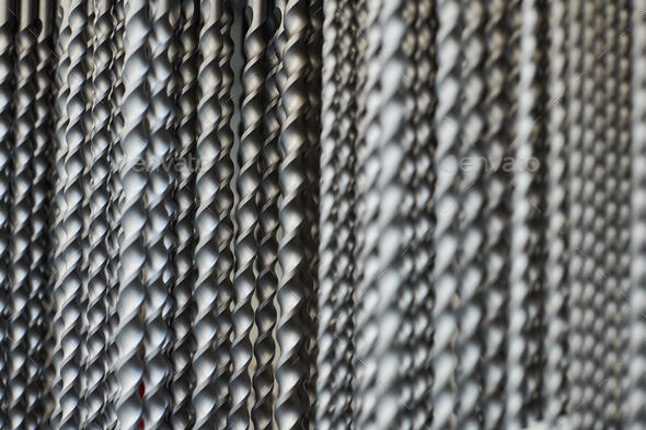 Bunch of hammer power drill bits in hardware store background, small depth of field