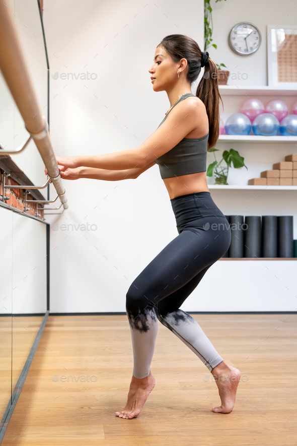 Woman doing exercise on barre - Stock Photo - Images