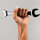Crop hand of woman holding wrench - PhotoDune Item for Sale