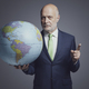 Businessman holding a globe and pointing - PhotoDune Item for Sale