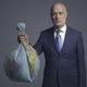 Businessman holding a polluted earth shaped as trash bag - PhotoDune Item for Sale