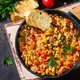 Turkish cuisine. Menemen Scrambled eggs in a cast iron frying pan on a stone countertop. - PhotoDune Item for Sale