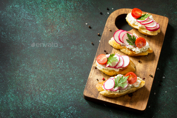 Brushetta or Crostini with Toasted Baguette,  Cheese, Radish and Tomatoes.   - Stock Photo - Images