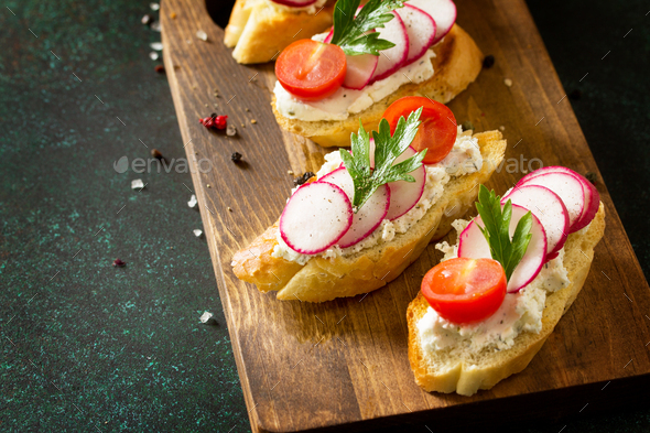 Brushetta or Crostini with Toasted Baguette, Cheese, Radish and Tomatoes. - Stock Photo - Images