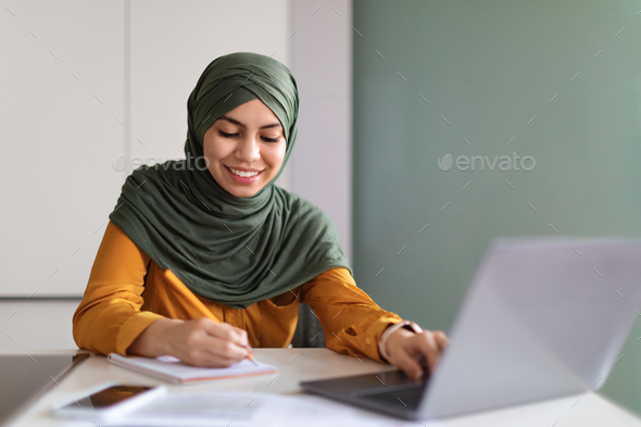 Online Education. Smiling Muslim Woman In Hijab Study With Laptop At Home - Stock Photo - Images