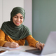 Online Education. Smiling Muslim Woman In Hijab Study With Laptop At Home - PhotoDune Item for Sale