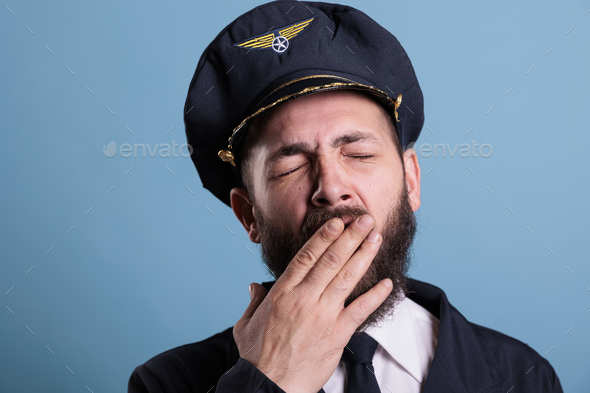 Tired airplane pilot yawning close up - Stock Photo - Images