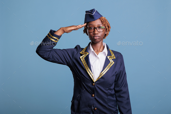 Portrait of female airline stewardess waving